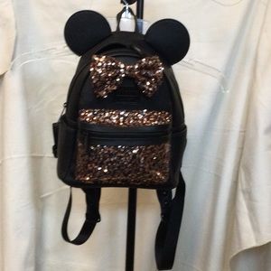 Disney mini backpack with rose gold ears and pouch.